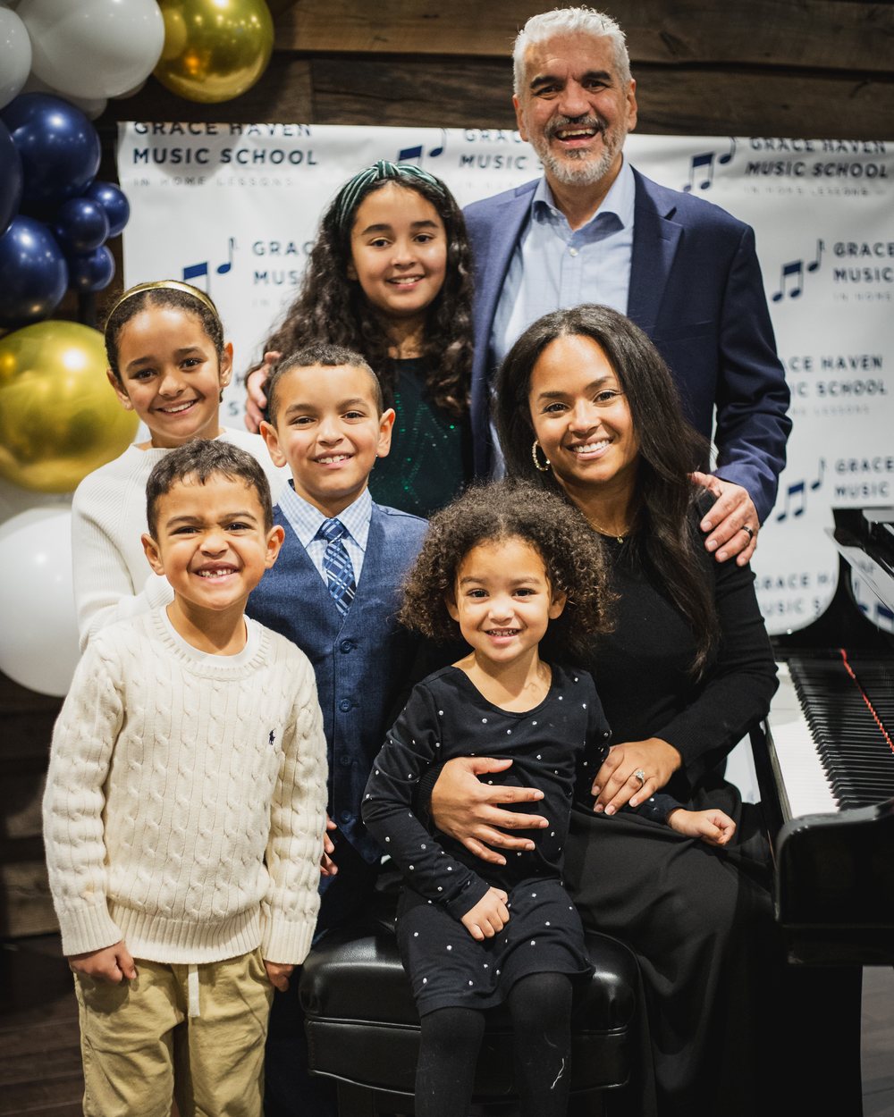Founder Niyani Armstrong with her family at a Grace Haven Music School recital