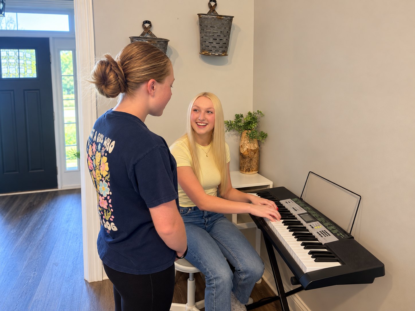 Grace Haven teacher Jordyn working with a student at the keyboard during an at-home lesson